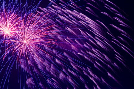 abstract holiday background: view on bright fireworks in night skyの写真素材