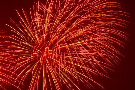 abstract holiday background: bright tracks of fireworks in night skyの写真素材