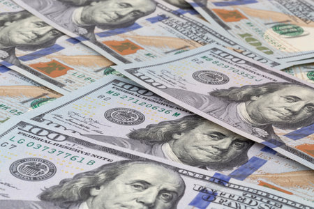 heap of one hundred United States dollars banknotesの写真素材