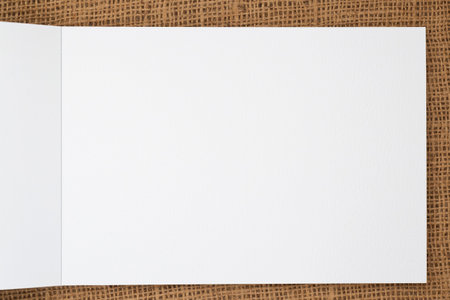 close up of white sheet of opened sketch book laying on canvasの写真素材