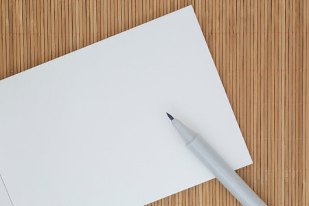 close up of marker laying on white page of sketch bookの写真素材