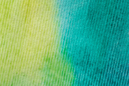 abstract background: close up of striped watercolor paper painted with yellow and turquoise paintの写真素材
