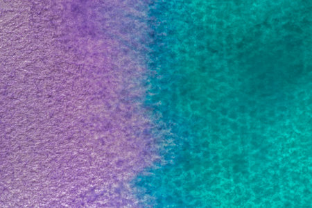 abstract artistic background: close up of watercolor paper stained with violet and turquoise paintsの写真素材
