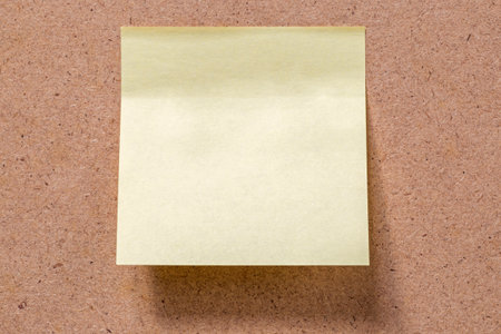 close up of yellow memory note sticked to brown memory boardの写真素材