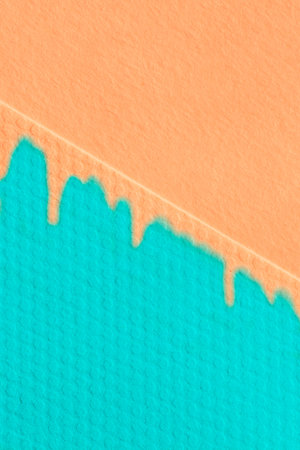 abstract geometric design with immitation of paint: close up of orange and turquoise sheets of...