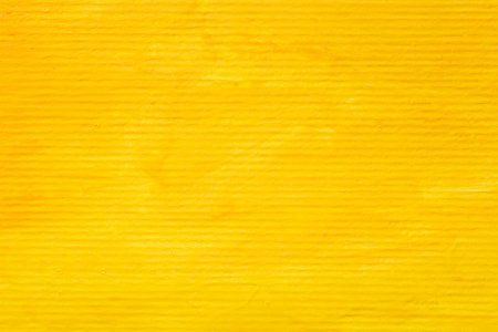 abstract background: close up of striped cardboard painted with yellow gouacheの写真素材