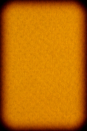 abstract background for Halloween card: close up of orange color textured cardboard with black frameの写真素材