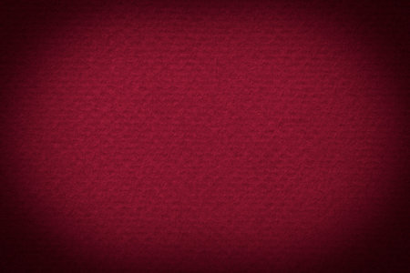 abstract Christmas background: dark red wine color cardboard shadowed at edgesの写真素材