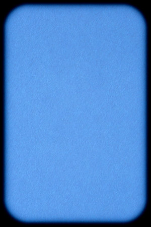 abstract blank wintry backdrop: blue cardboard with rounded corners against black backgroundの写真素材