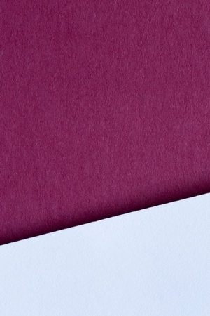 simple design: white sheet of paper against maroon cardboardの写真素材