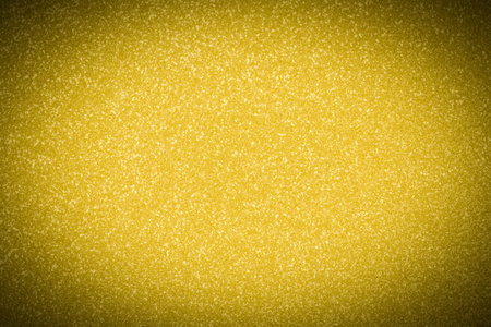 abstract holiday background: flat blank golden color spotted texture with shadowed frameの写真素材