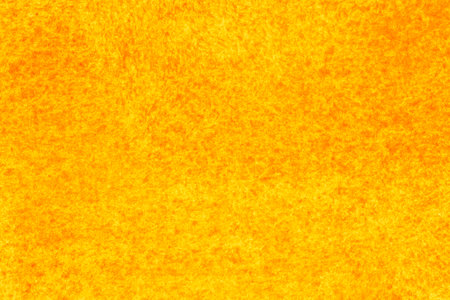abstract summer backdrop: close up of canvas stained with yellow and red paintsの写真素材