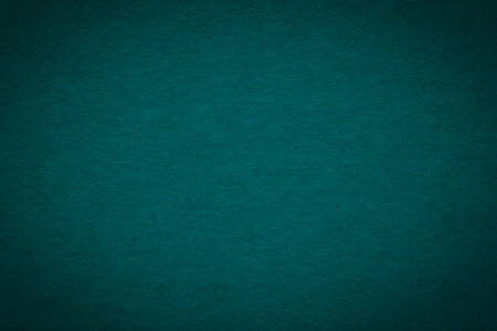 abstract dark emerald color backdrop: close up of blank craft cardboard background with shadowed edgeの写真素材