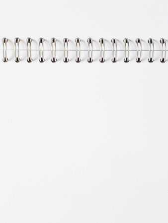 close up of blank page of opened album with metallic spiral binderの写真素材
