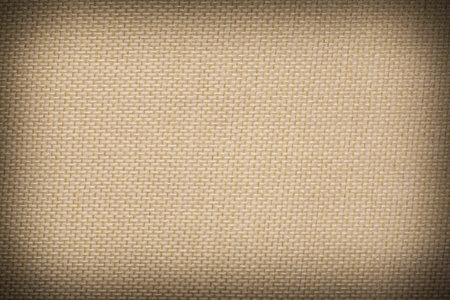 abstract beige message wall background: close up of woven canvas texture with shadowed edgeの写真素材