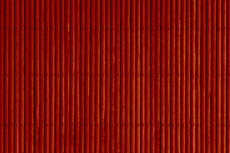 abstract backdrop: close up of red mat made of bamboo sticksの写真素材