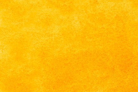 abstract artistic backdrop: close up of canvas stained with yellow and orange paintsの写真素材