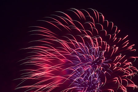 abstract holiday card backdrop: colorful fireworks in dark night skyの写真素材