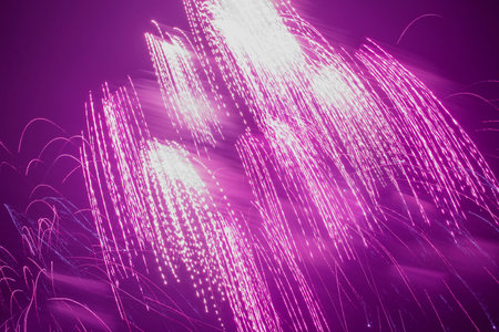 abstract holiday card backdrop: bright white color fireworks in dark purple night skyの写真素材