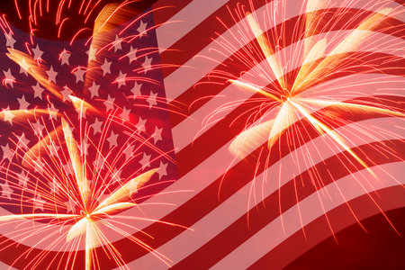 Independence Day holiday background: bright fireworks against waved United States of America flagの写真素材