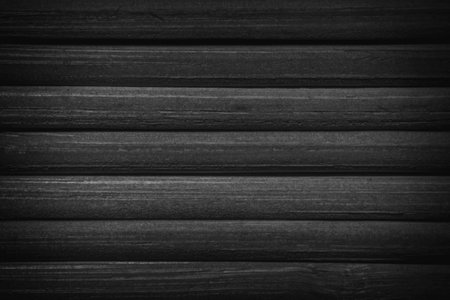 abstract black and white background: close up of shadowed at edges mat made of bamboo sticksの写真素材