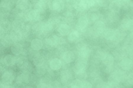 abstract holiday backdrop: close up of light green bokeh circles backgroundの写真素材