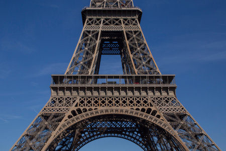 close up of center part of Eiffel Tower in Paris against blue skyの写真素材