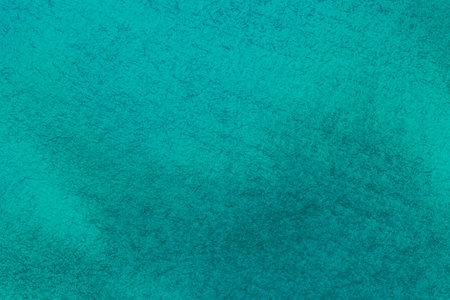 abstract cover design backdrop: close up of canvas texture stained with emerald color paint
