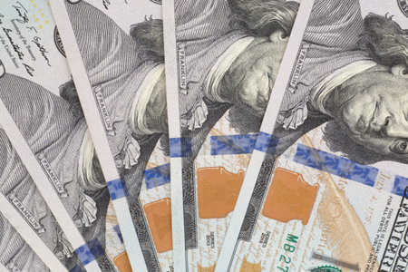 abstract financial backdrop: close up of fan shaped United States one hundred dollars banknotes
