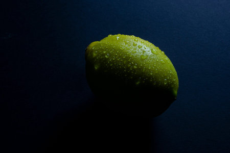 lemon with water drops on black background
