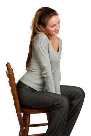 Pretty girl sit on wooden chair の写真素材