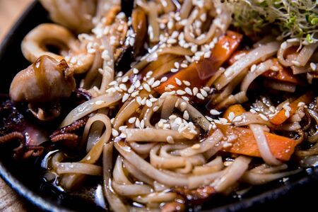 Chinese noodles with mussels and shrimps on the wooden table.の写真素材