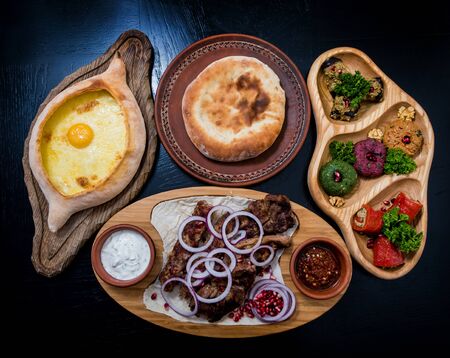 Georgian cuisine food set. Khachapuri, dolma, satsivi, khinkali, pkhali. Georgian restaurant. Backgroundの写真素材
