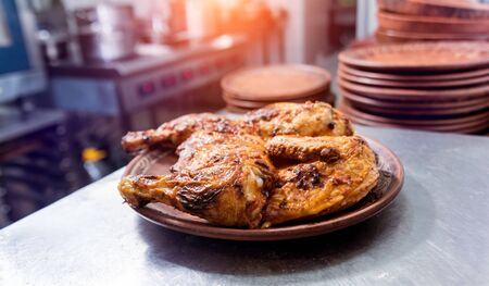 Rroasted chicken with olive oil on the kitchen table. Restaurant.の写真素材