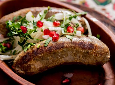 Grilled sausage in a clay pot. Georgian restaurant.の写真素材