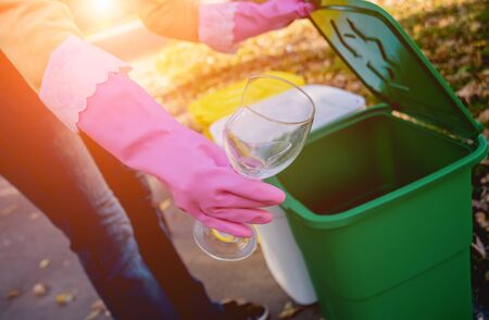Volunteer girl sorts garbage in the street of the park. Concept of recycling. Zero waste concept. Natureの写真素材