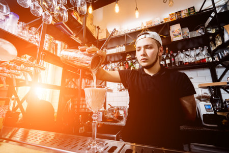Bartender is making cocktail at bar counter. Fresh cocktails.