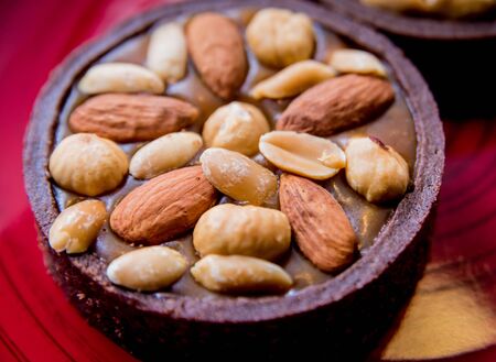 Chocolate cookies with almond nuts on a red plate. Restaurant. Backgroundの写真素材