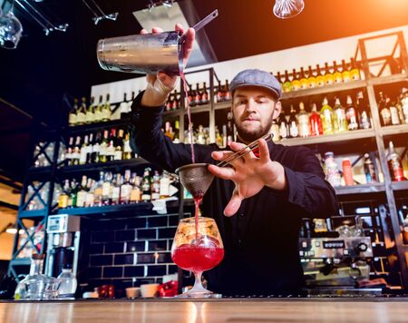 Bartender is making cocktail at bar counter. Fresh cocktails. Barmanの写真素材