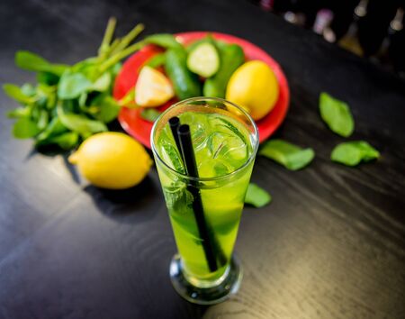 Non alcoholic cocktail with lime and mint at wooden bar counter. Restaurant. Backgroundの写真素材