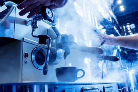 The bartender makes the coffee, cappuccino, cocoa, drink at the bar. Barista. Restaurant. Backgroundの写真素材