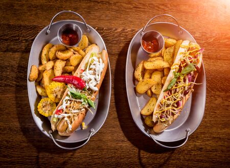 Hotdogs and French fries on a dishes. Fast food meal. Restaurant. Backgroundの写真素材