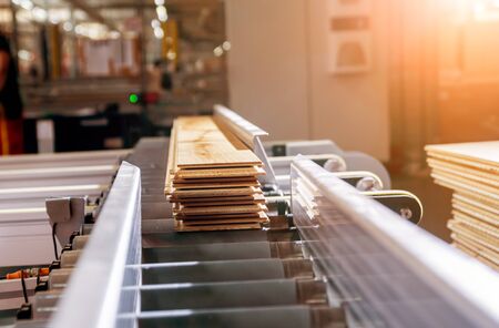 Production line of the wooden floor factory. CNC automatic woodworking machine.の写真素材