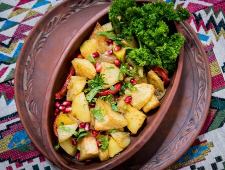 Fried potatoes with pieces of meat in a clay pot. European cuisine. Backgroundの写真素材