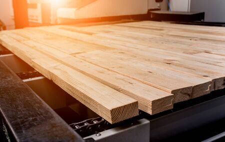 Production line of the wooden floor factory. CNC automatic woodworking machine. Industrial backgroundの写真素材