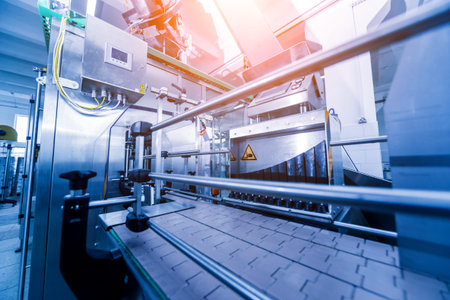 Automatic filling machine pours water into plastic PET bottles. Brewing production. Industrial...