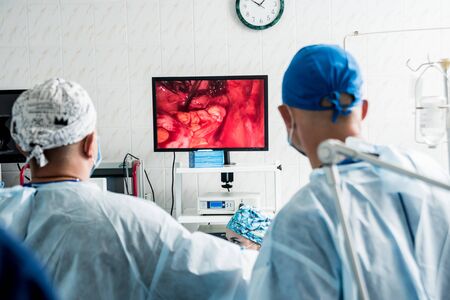 Process of gynecological surgery operation using laparoscopic equipment. Group of surgeons in operating room with surgery equipment. Medical backgroundの写真素材