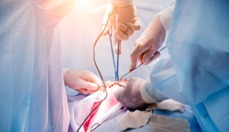 Surgeon and assistants in operating room with surgery equipment. Medical background