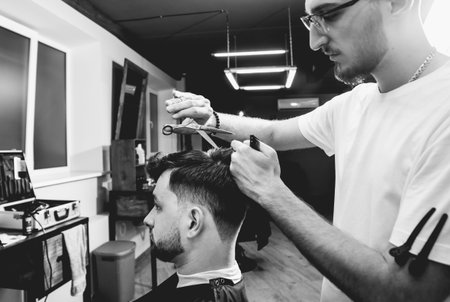 Young man with trendy haircut at barber shop.
