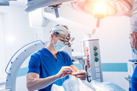 Spinal surgery. Group of surgeons in operating room with surgery equipment. Laminectomy. Modern medical backgroundの写真素材